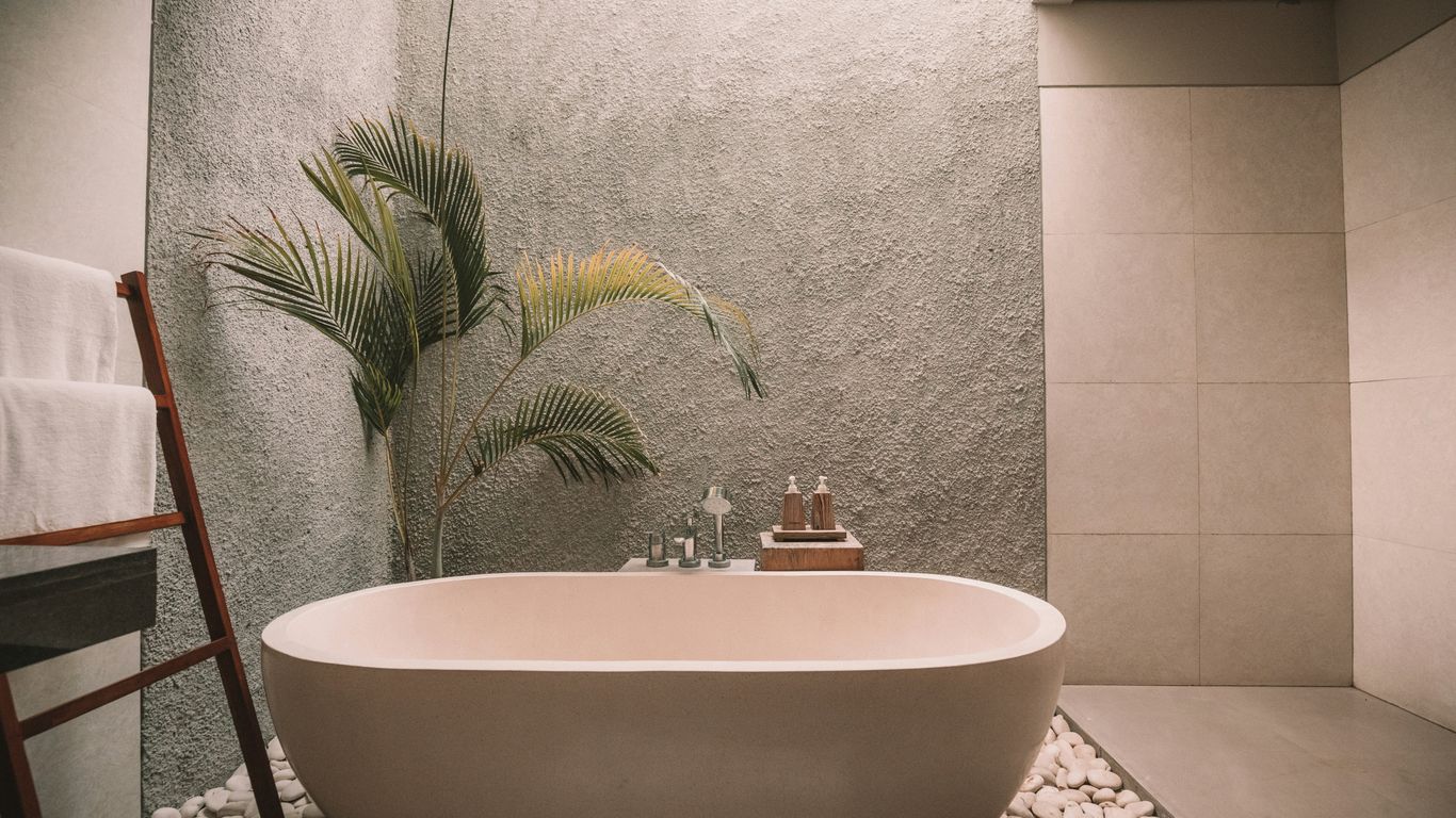 Warm travertine bathroom with textured walls