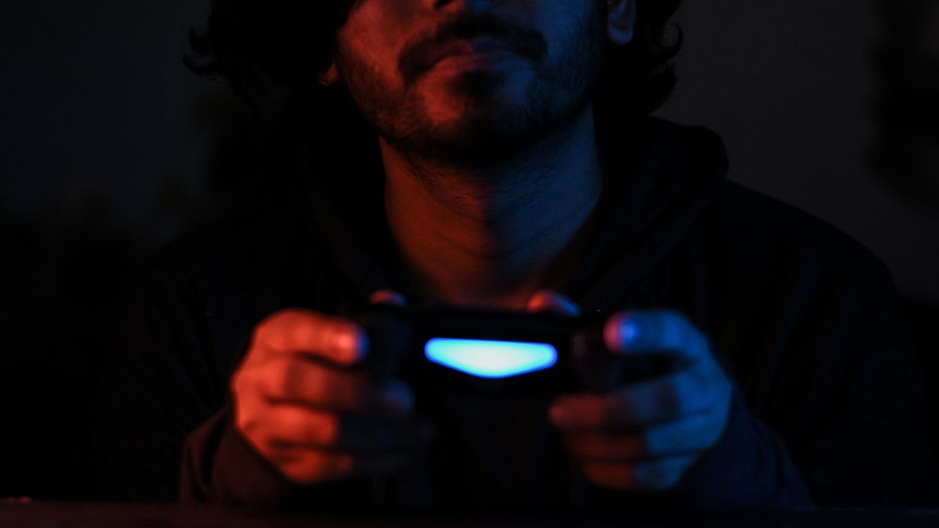 man in black jacket holding black smartphone