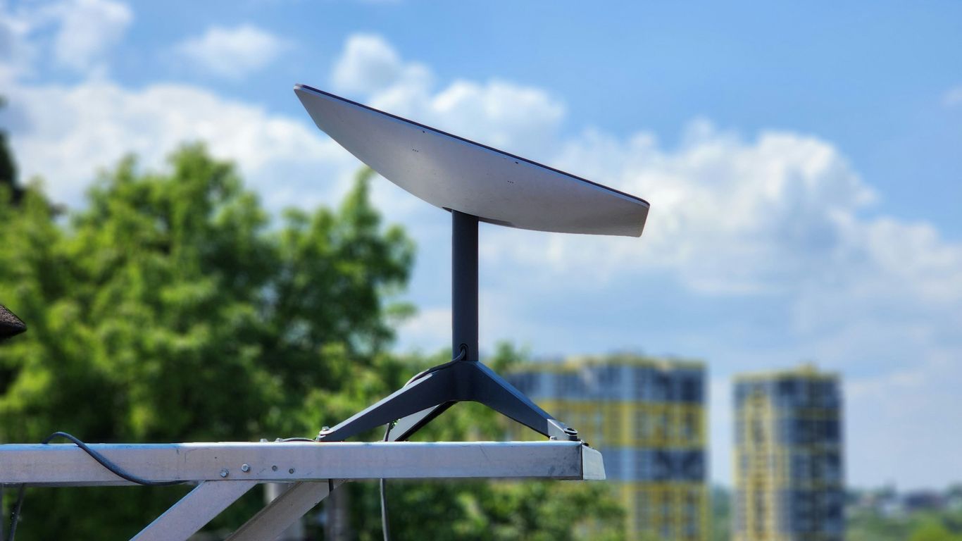 a white surfboard sitting on top of a metal pole
