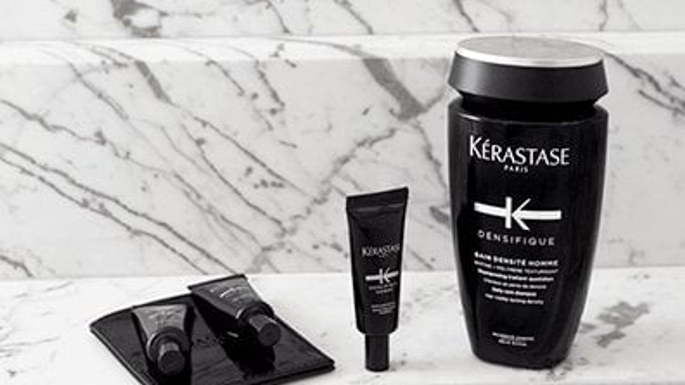 Kérastase hair care products displayed on marble surface.