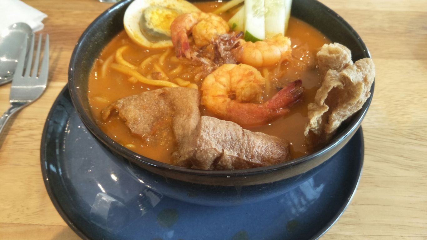 a bowl of soup on a table with a fork