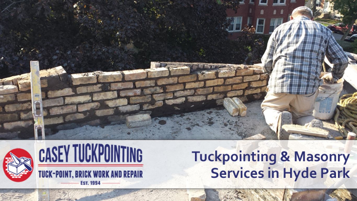 Masonry work on a brick wall with a level and tools.