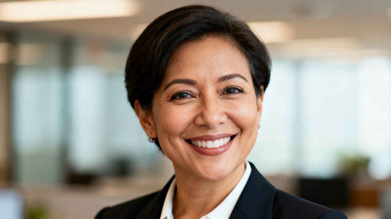 Angela Nancy, INPress efficiency expert, smiling in office.