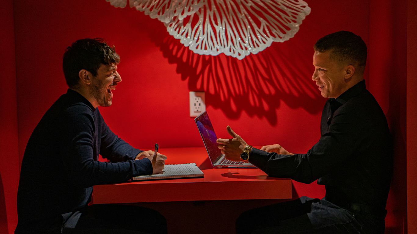 man in black long sleeve shirt sitting on chair