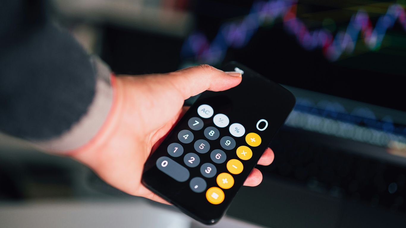 a person holding a remote control in their hand