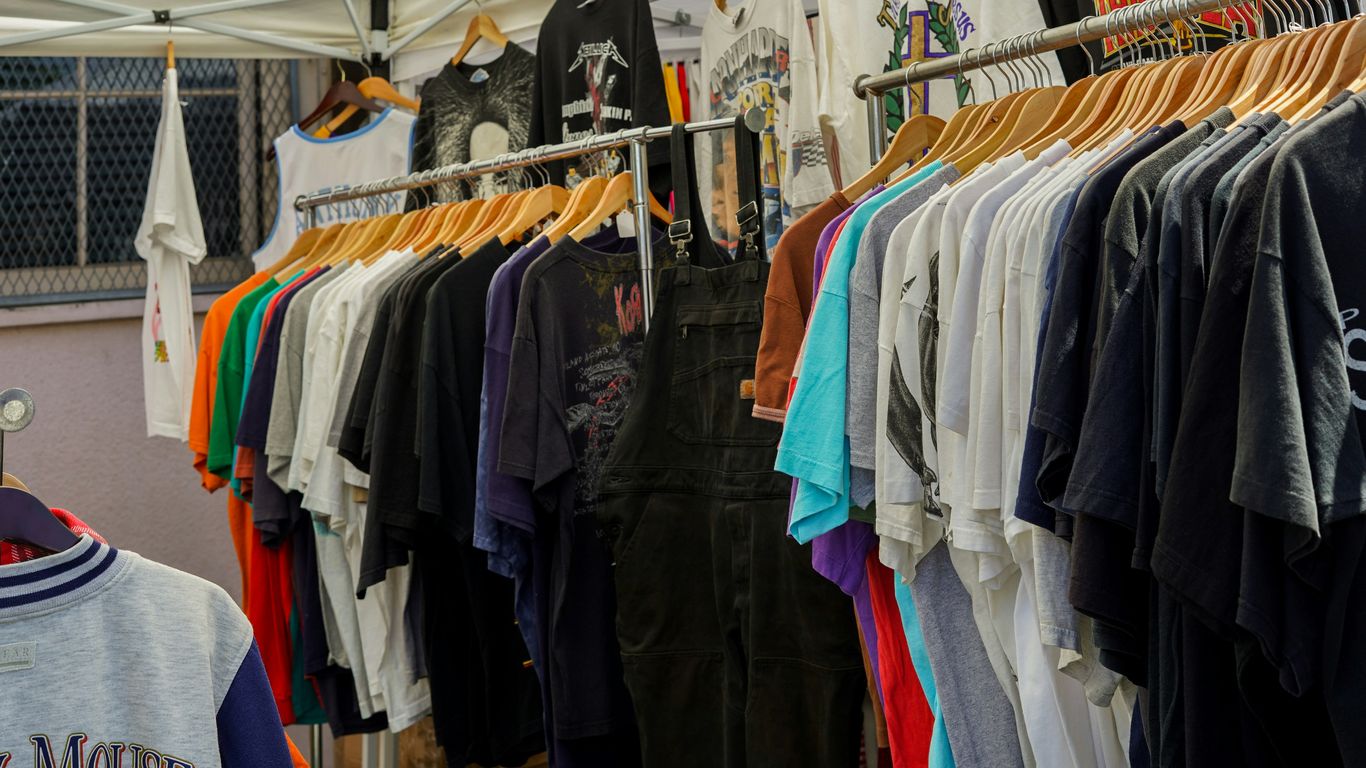 a bunch of shirts hanging on a rack