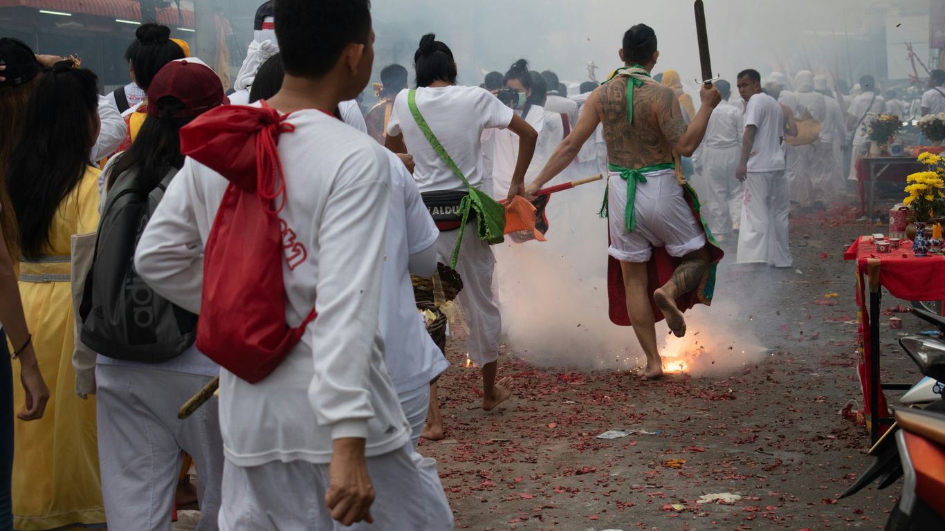 people in white uniform holding green stick during daytime