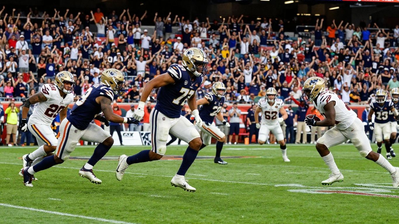 Football game action with cheering fans in a stadium.