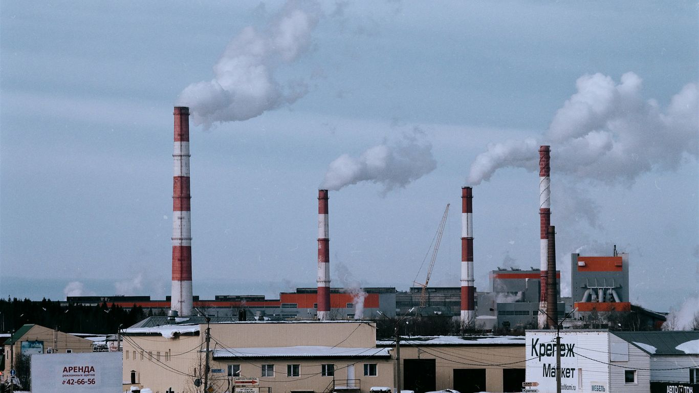 a factory with a lot of smoke coming out of it