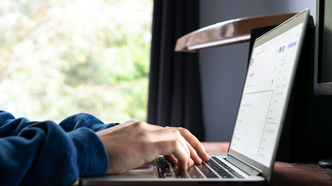person using macbook pro on table