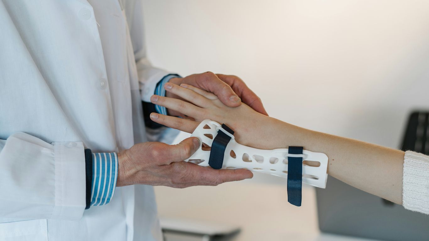 Surgeon working with collaborative robotic orthopedic arm