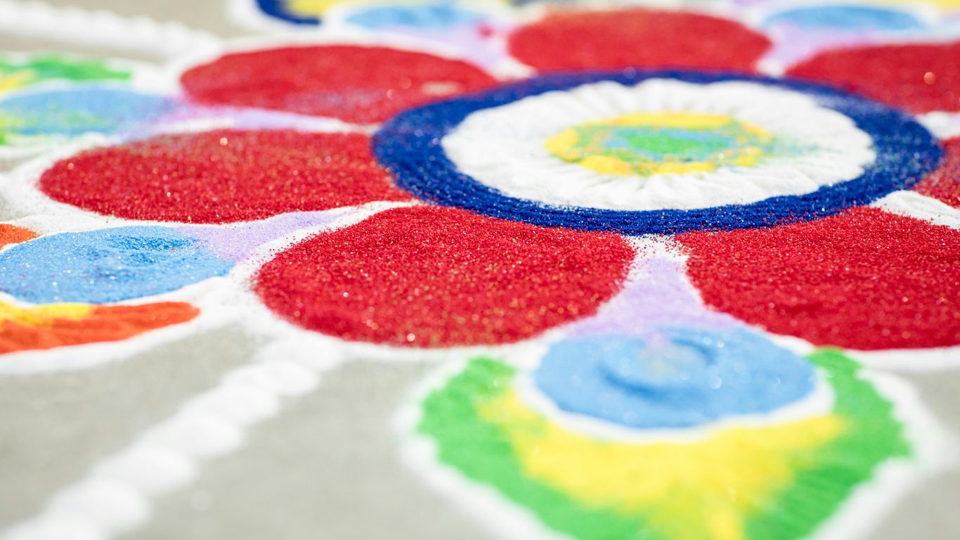 Visitors admiring traditional colorful rangoli patterns at home