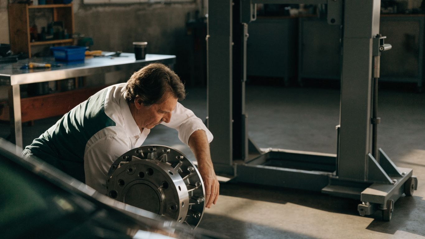 Technician inspecting a gearbox in a repair shop