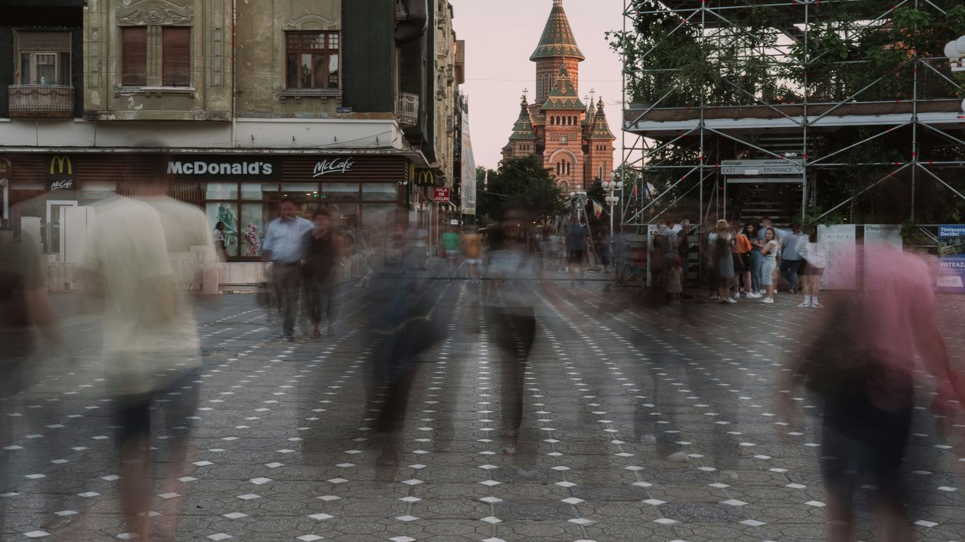 a blurry photo of people walking down a street