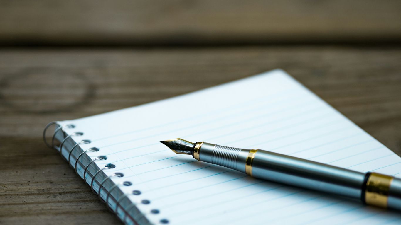 A pen resting on a notepad