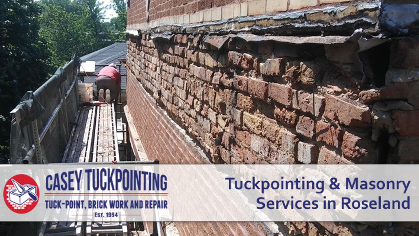 Masonry work on a brick building with scaffolding and a worker.