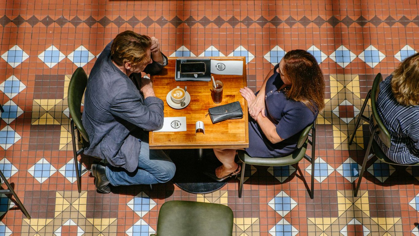 Couple sitting at a table in a cafe