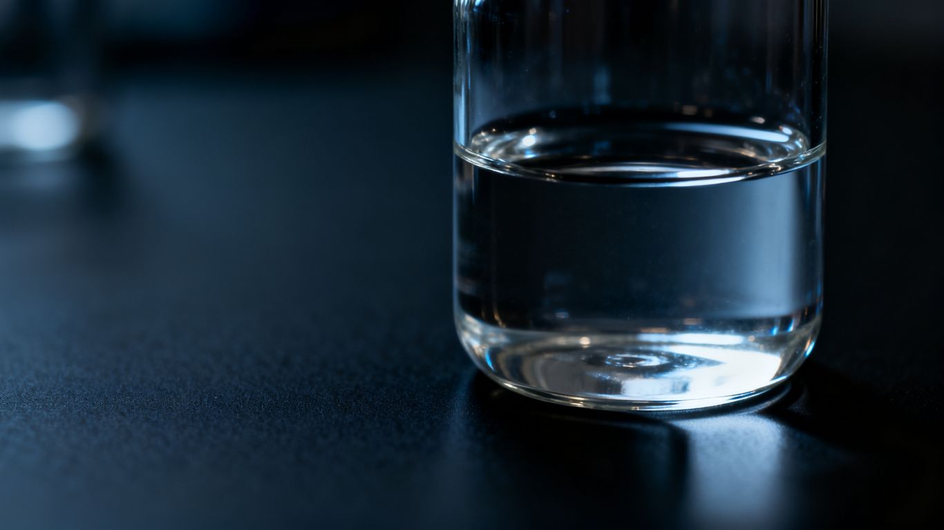 A close-up of a glass vial containing liquid