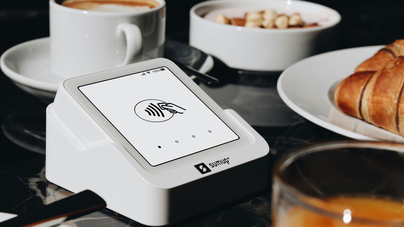 A table topped with plates of food and cups of coffee