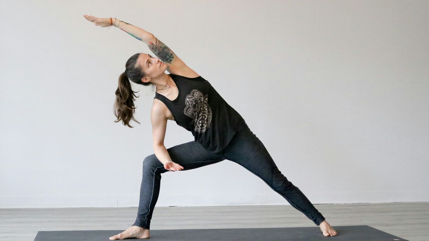 woman in black tank top and blue denim jeans jumping