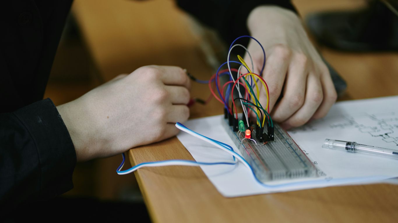 Someone is working on a circuit board.