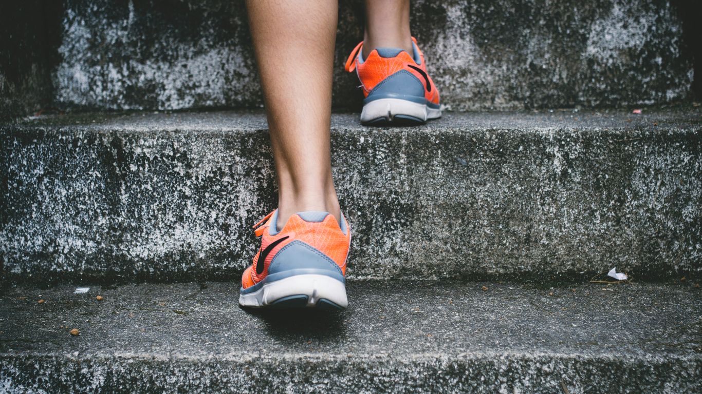 A practitioner uses a strap for a leg stretch