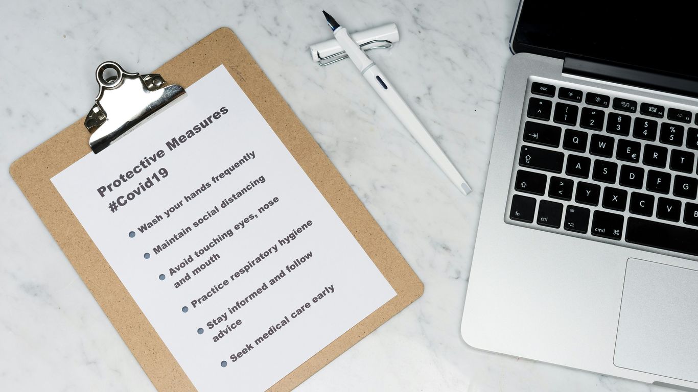 white and brown card on silver macbook