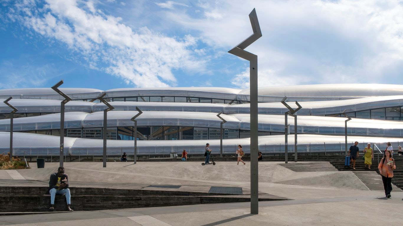Modern building with wavy facade and people outside