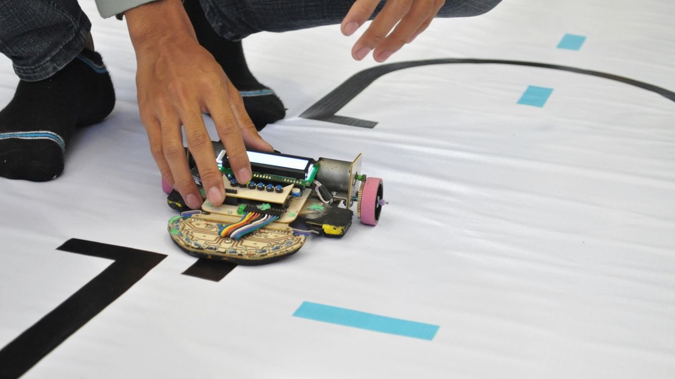person holding green and black toy car