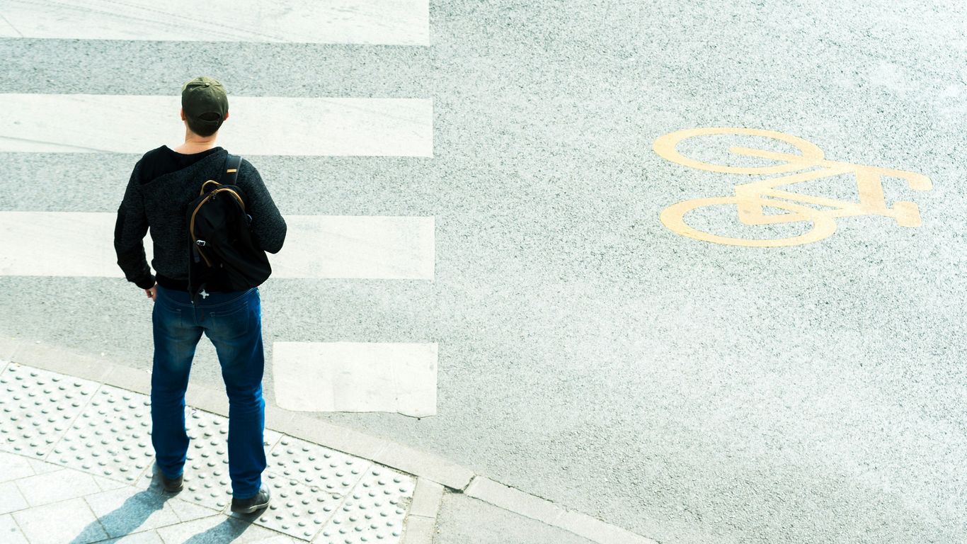 a man standing in front of a crosswalk