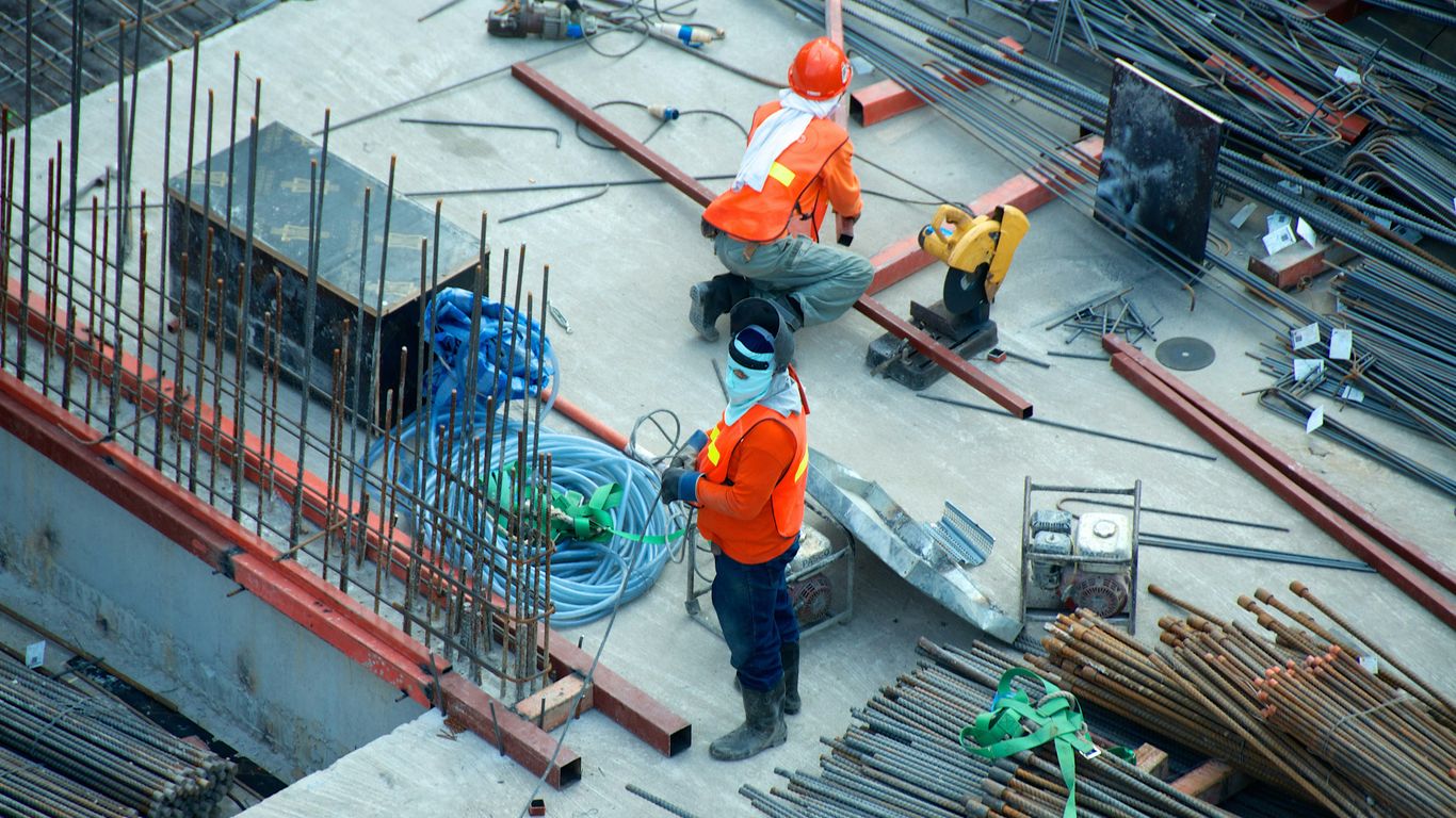 Construction teams coordinating on a modern office site