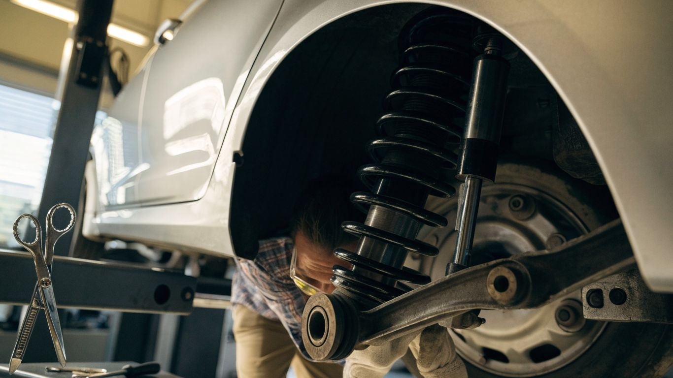 Technician inspecting a car suspension