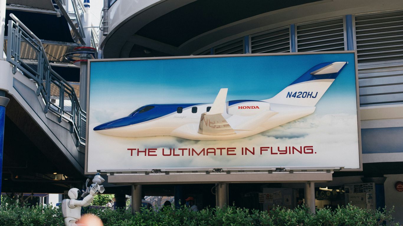 a billboard with a plane on it in front of a building