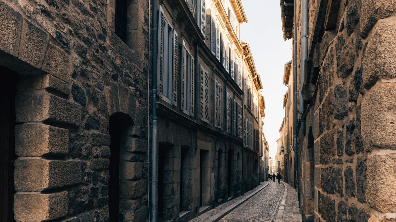 Historic Agde street with dark stone buildings