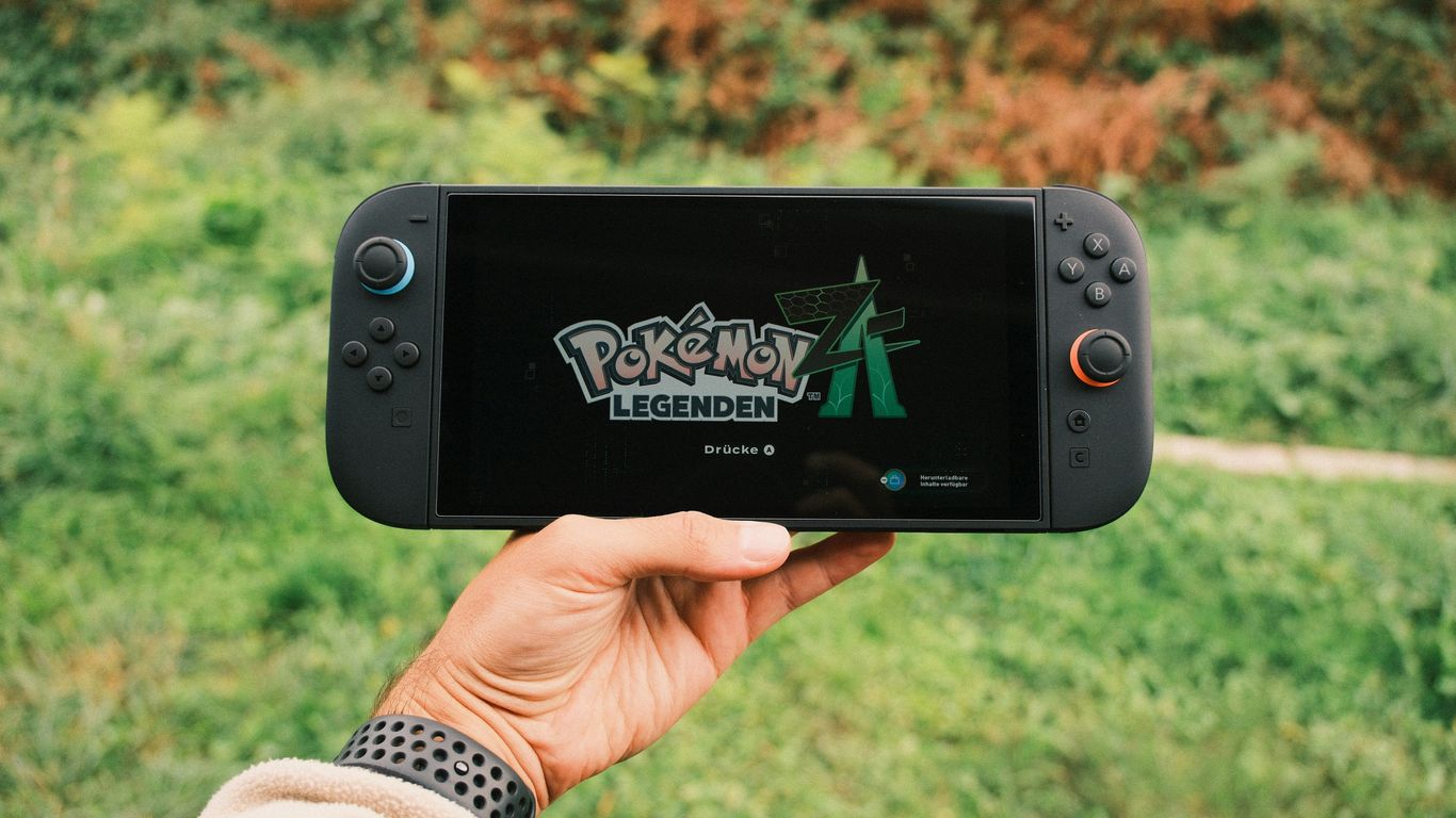 Hand holding a nintendo switch playing pokémon legends