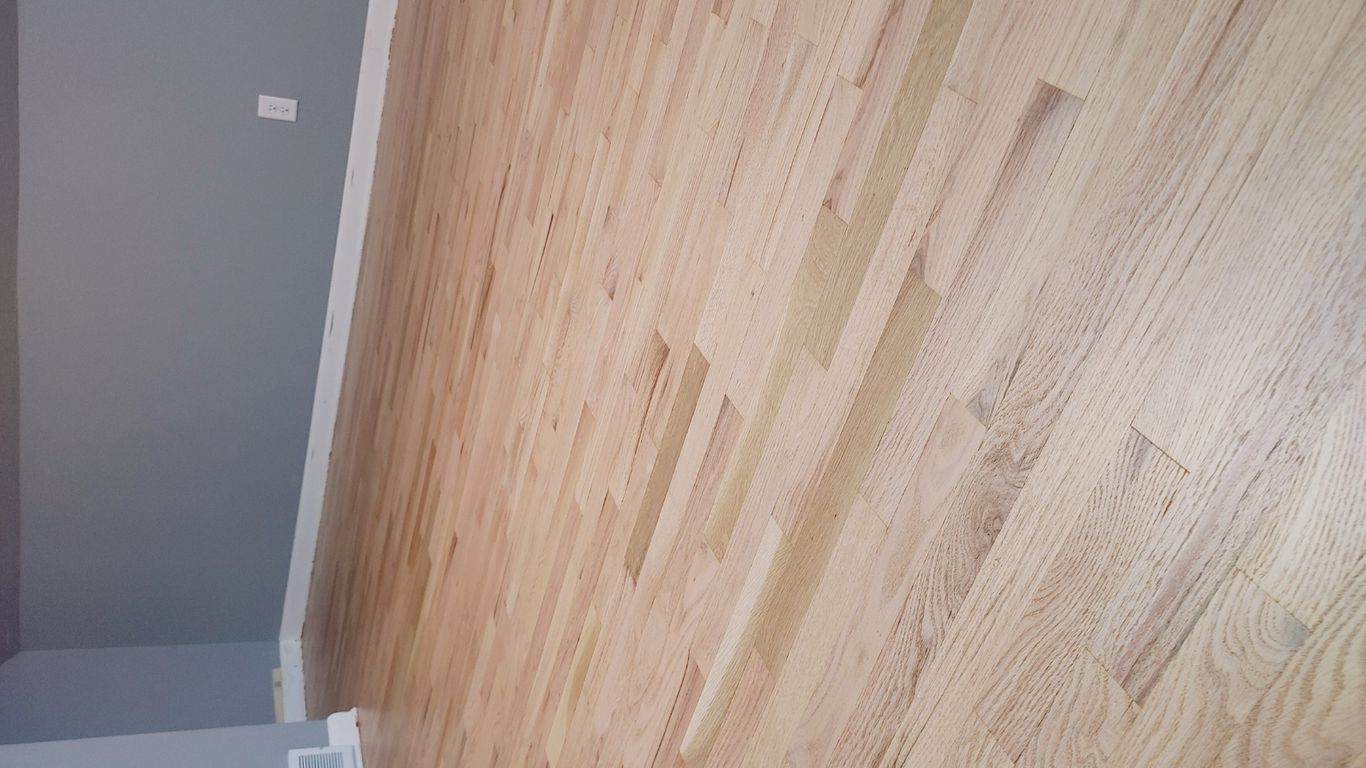 Light wooden flooring in a spacious, minimal room.