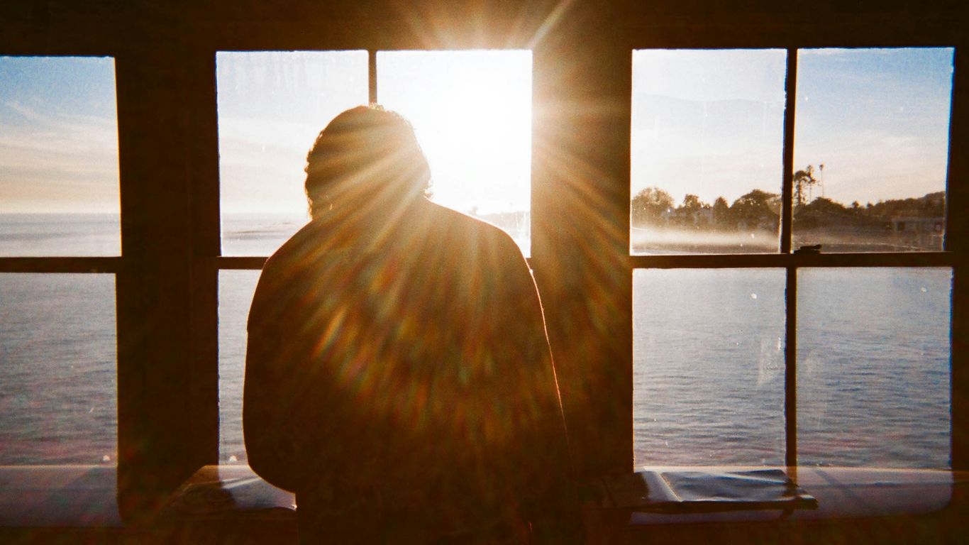 man sitting in front of view window