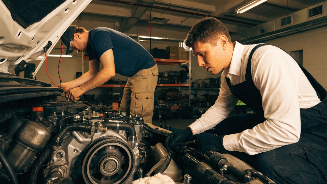 Mechanic inspecting a used engine during installation