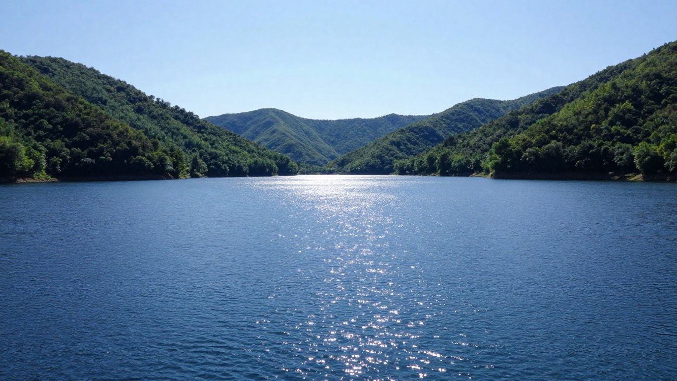 Blue Rock Lake with green hills and blue water.