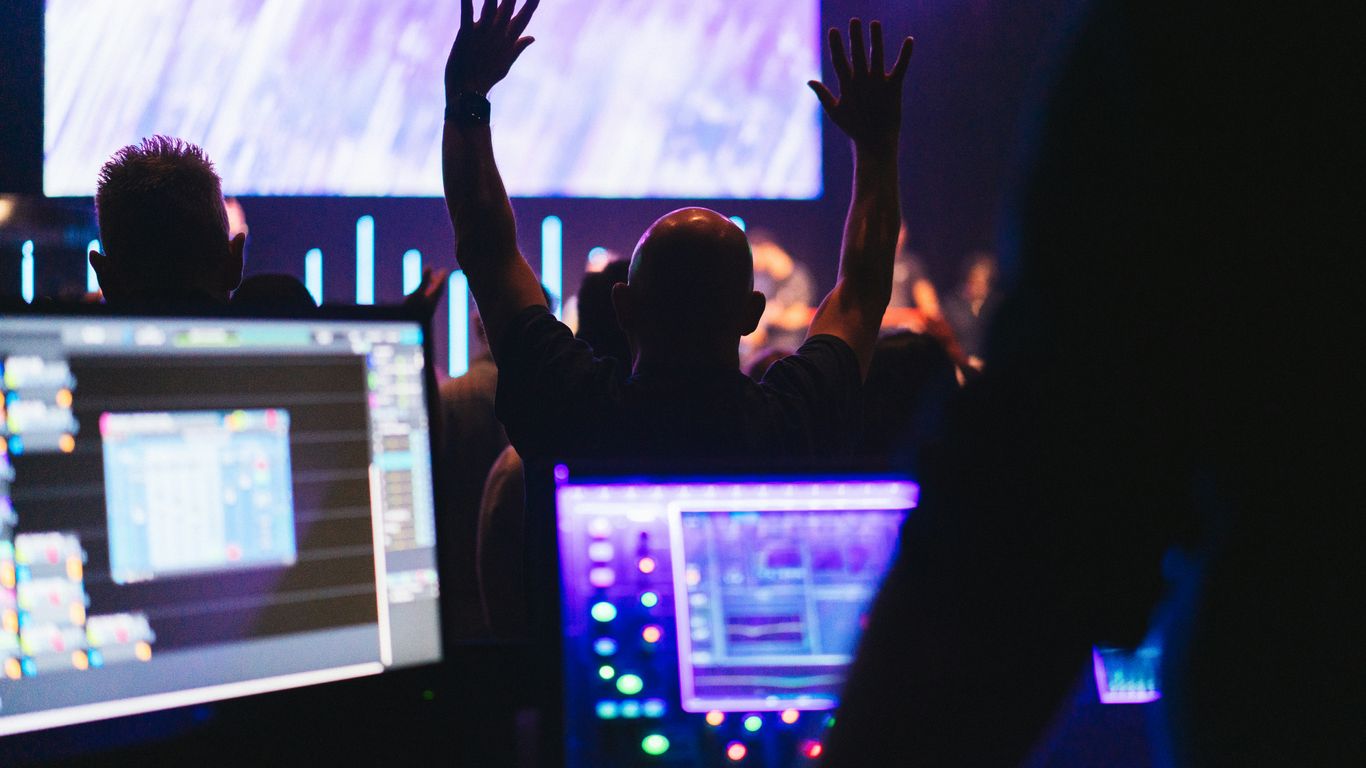 A group of people standing in front of computer monitors