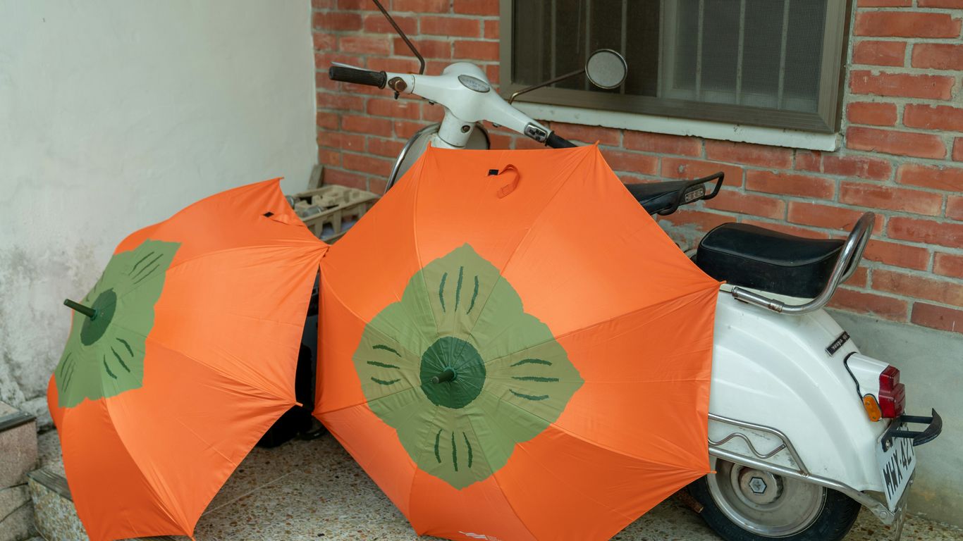 red umbrella on white car