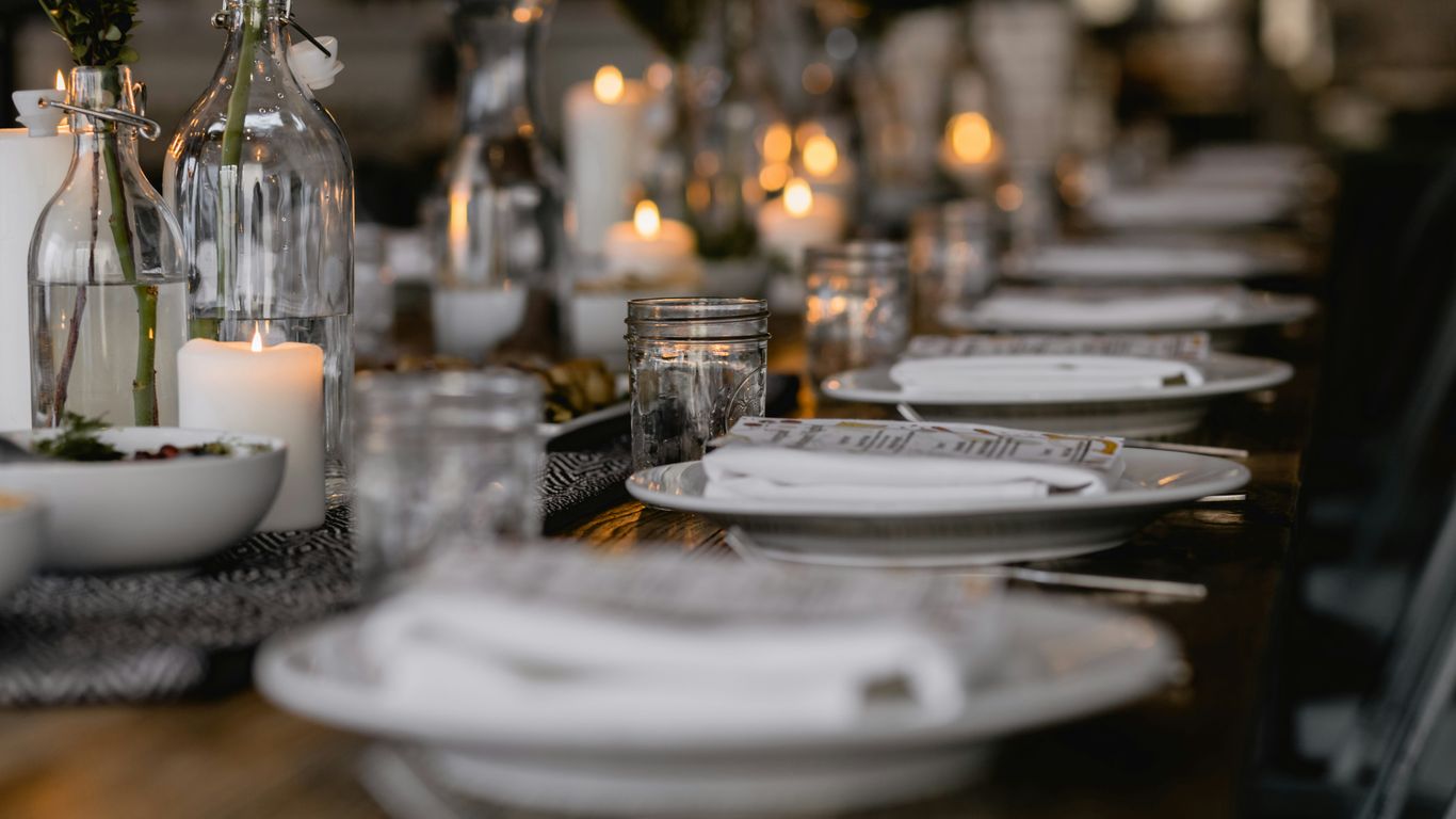 Styled black marble dining table with soft lighting