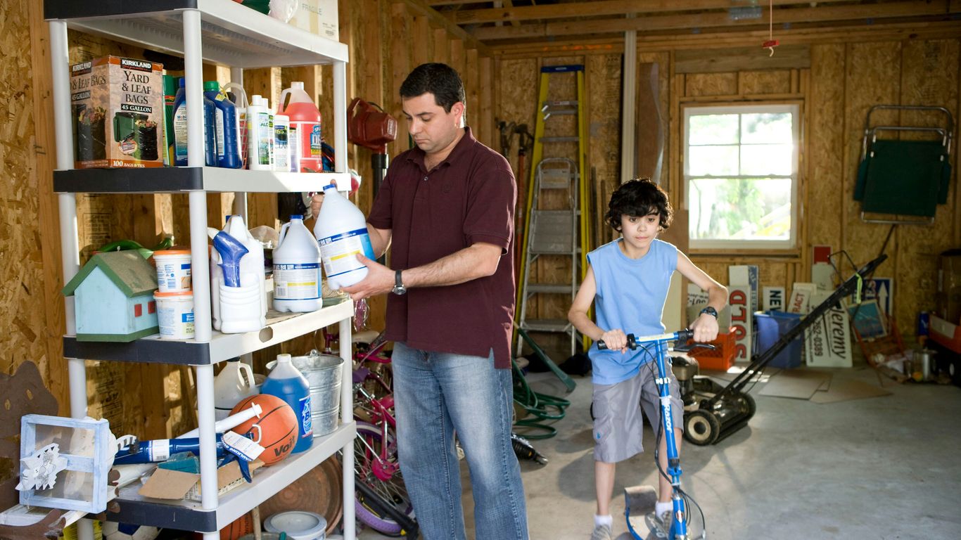 man in brown polo shirt and blue denim jeans standing beside man in blue denim jeans