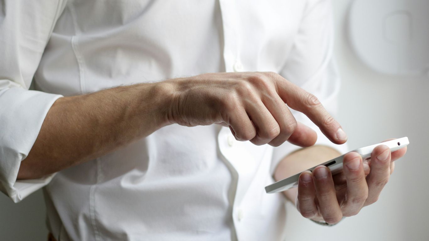 A focused individual reviewing online notifications for safety