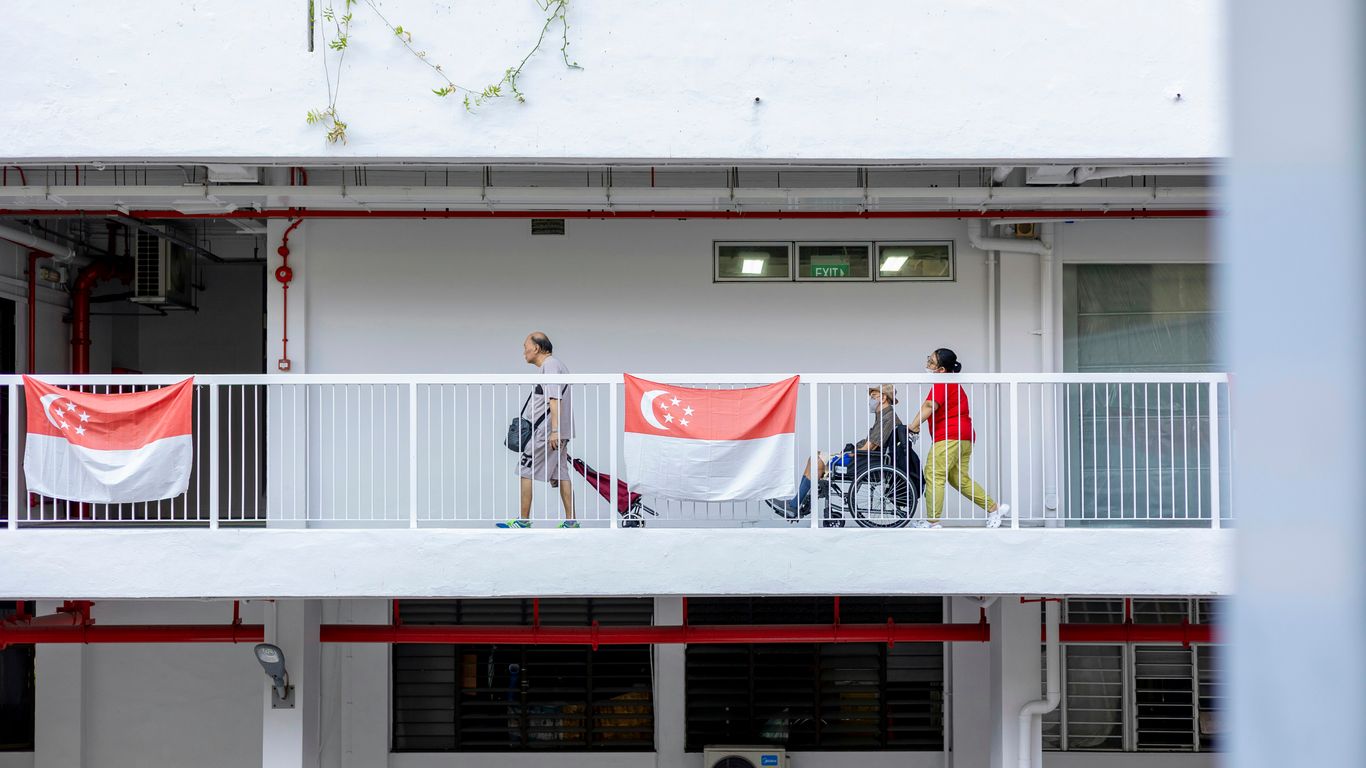 a group of people walking across a bridge
