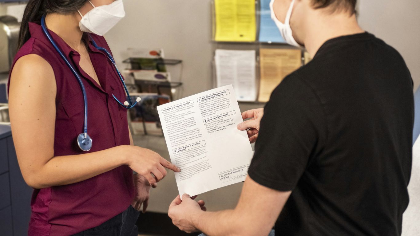 woman in black shirt holding white printer paper