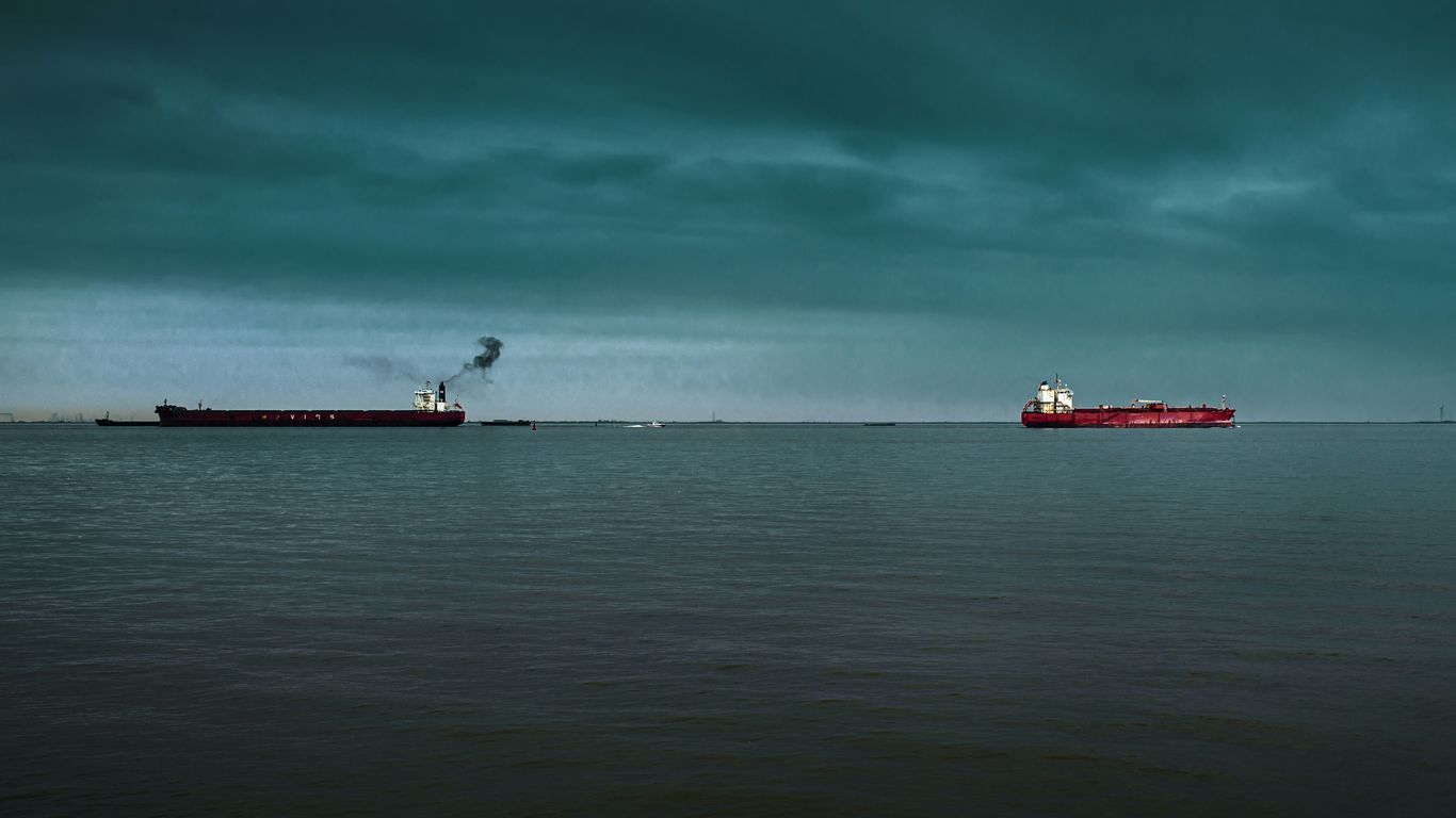 red and white ship on sea under blue sky