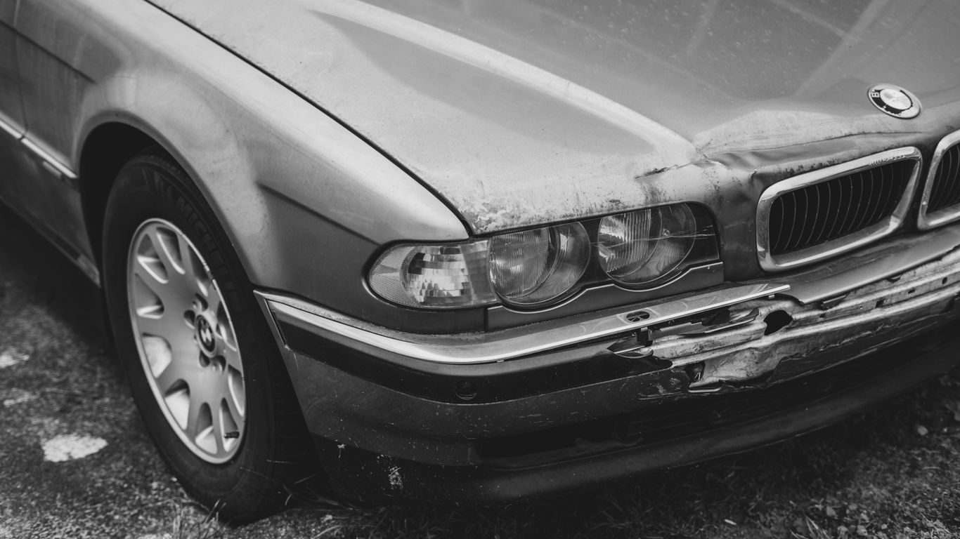 A car that is sitting in the grass