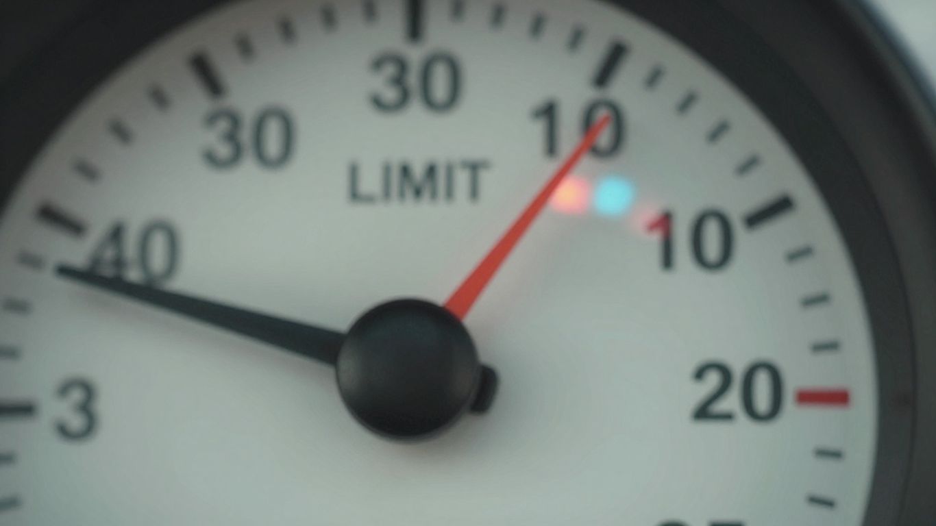Speedometer showing a high speed with police lights in background.