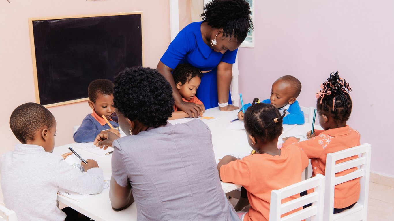 Preschool teacher guiding children in a classroom